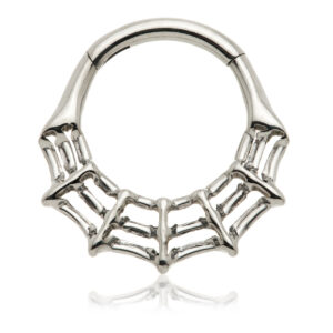 Close-up of a cobweb-shaped septum ring worn in a pierced septum